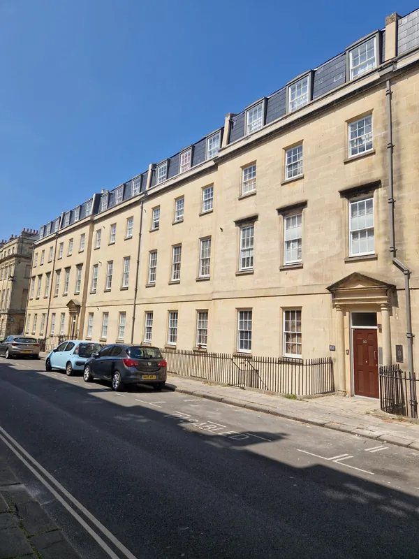 Sunlit Bath stone terrace elevation with the renewed roof above