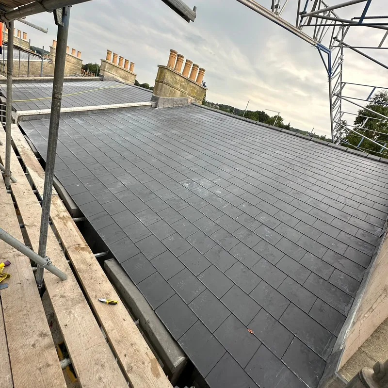 Roof covering nearing completion viewed from the scaffold access