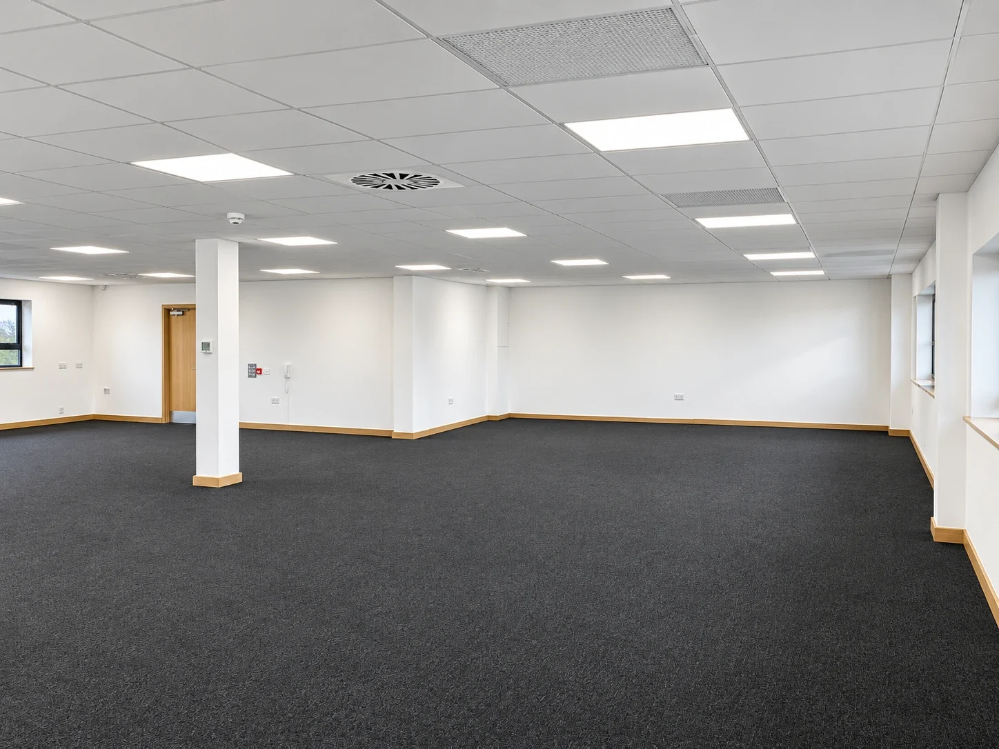Open-plan office ceiling with reinstated lighting and ventilation grilles