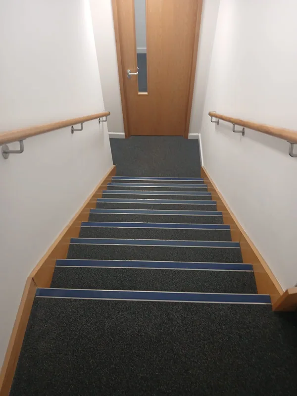 Stair with new carpet, nosings and varnished handrails