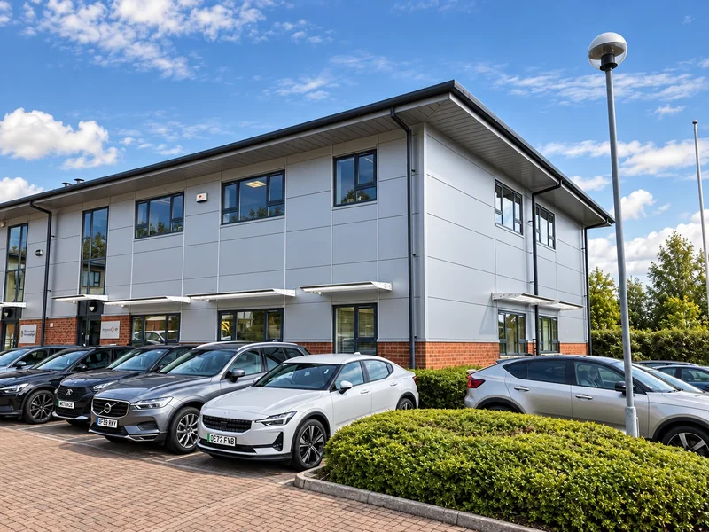 Two-storey office building with restored window frames and brick and cladding elevations