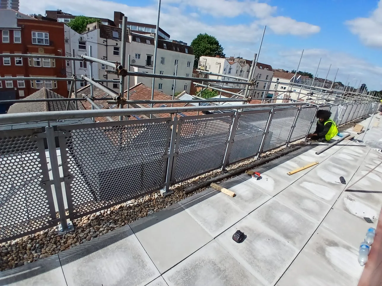 Renewed balcony walkway with new paving slabs and mesh balustrade