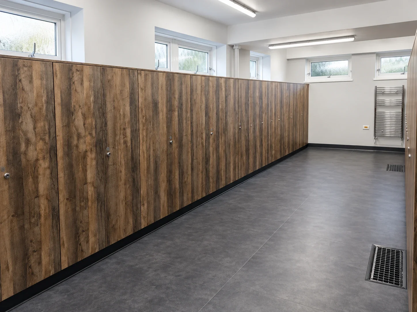 Run of timber-effect WC cubicles in a refurbished washroom