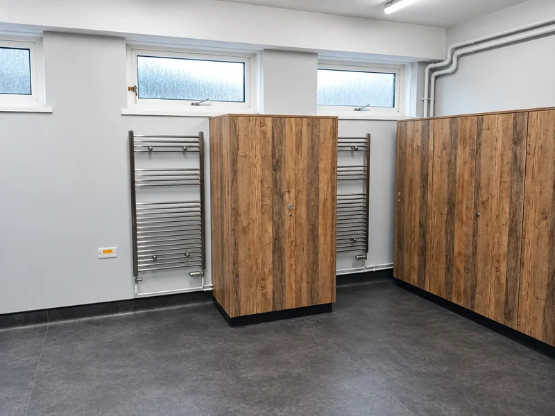 Heated towel rail beside new cubicles and refurbished walls