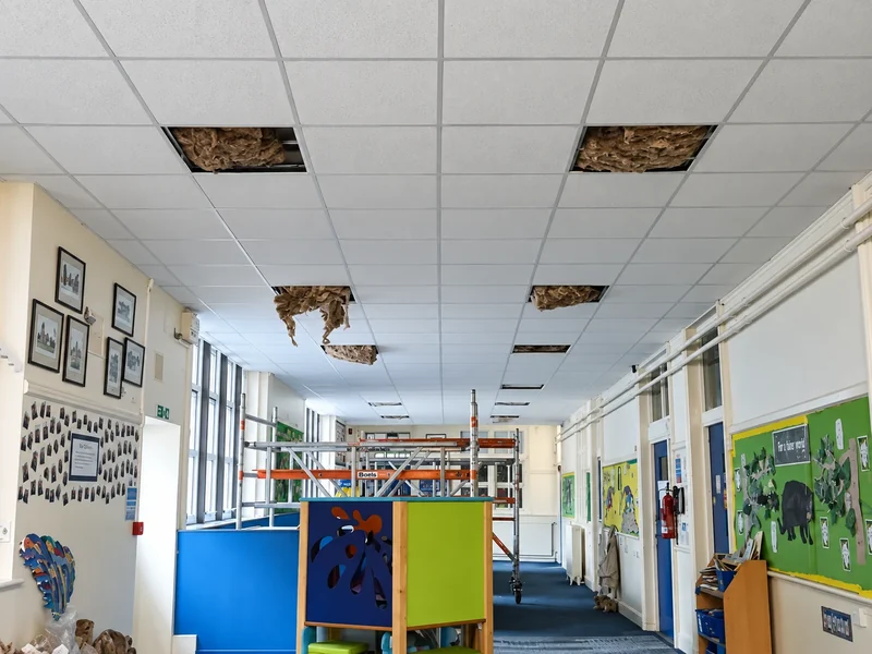 New suspended ceiling grid and LED panels in a school classroom